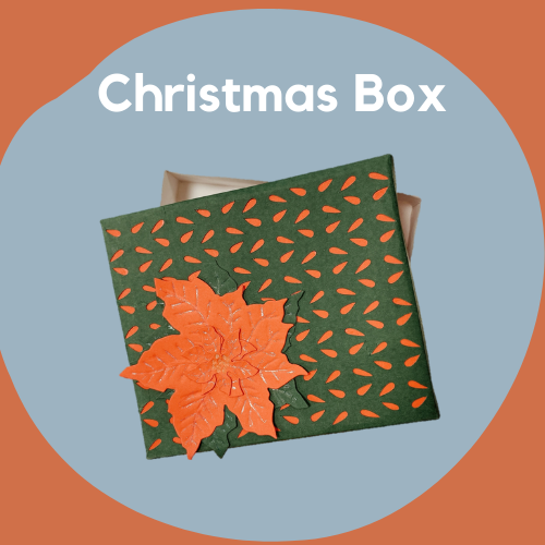 A decorative box made out of paper in Christmas colors